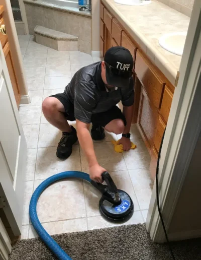 A Person Cleaning Tile